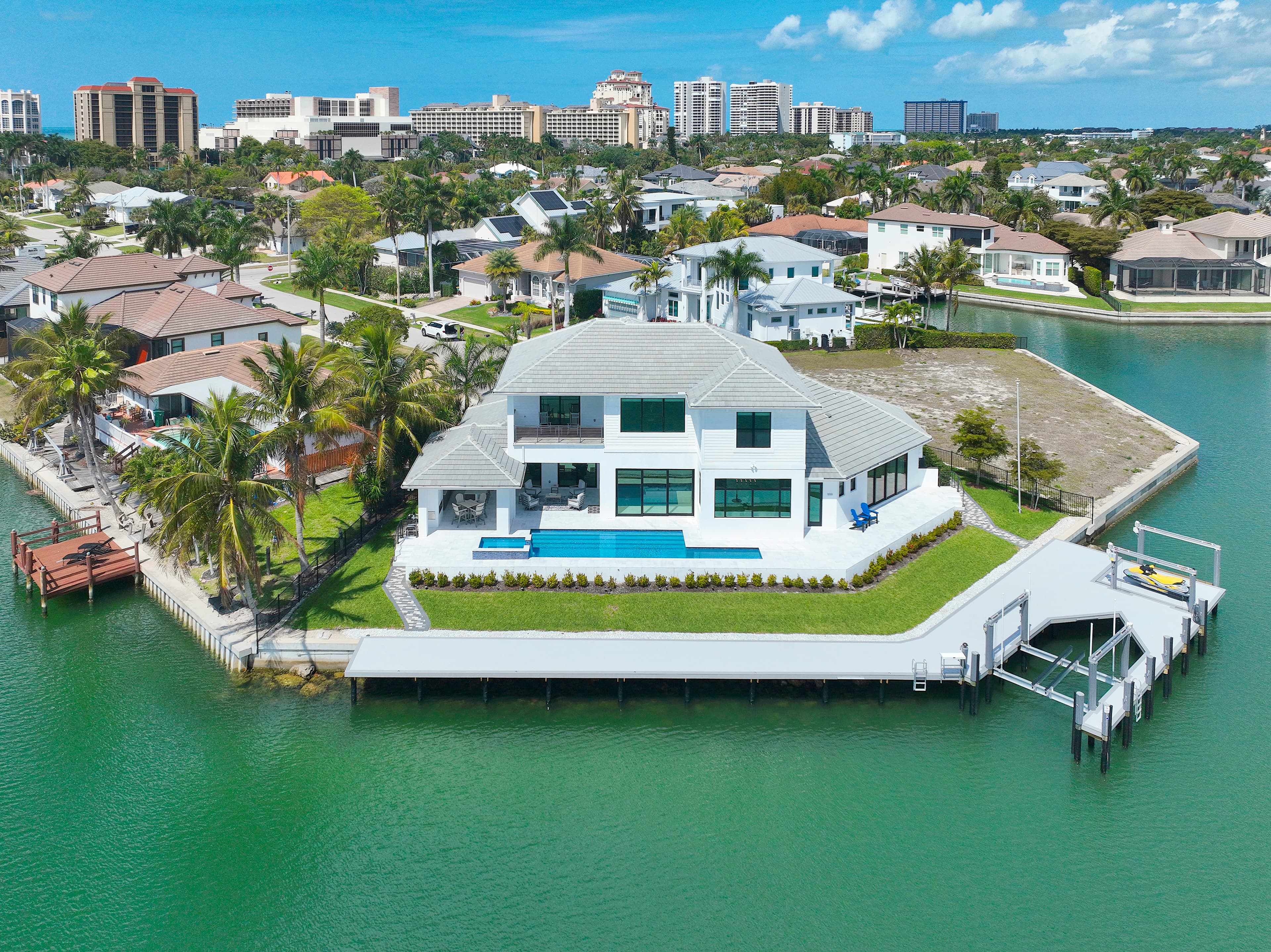 Experience the pinnacle of waterfront living at 999 Spruce Court. This magnificent, custom-built home located on a highly desirable tip lot offers 5 bedrooms plus den, 5 and half baths, 3 car garage, 169' of waterfrontage, spectacular wide water views and is only minutes from Marco Island's pristine white sand beach.