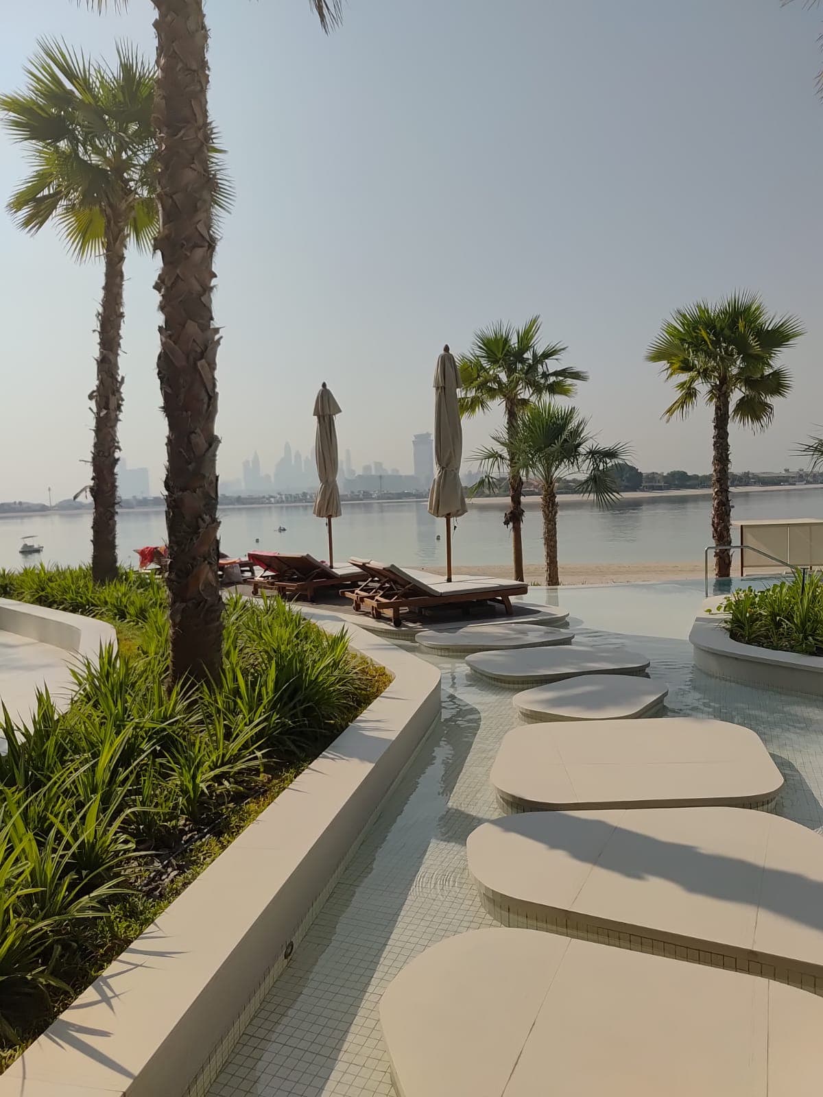 Beachfront living on Palm Jumeirah with private-club inspired amenities, panoramic sea and skyline views, direct beach access, resort-style pools, wellness spaces, and elegant residences designed for a calm luxury lifestyle.
Located on the East Crescent of Palm Jumeirah, the project offers freehold residences with 1 to 4 bedroom layouts, private beach access, an infinity pool, clubhouse, fitness and wellness facilities, kids areas, padel court, valet arrival, and elegant resort-style interiors.